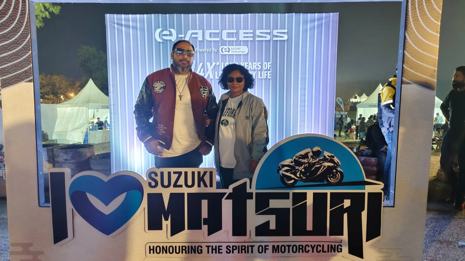 Visitors posing at Suzuki Access e-Access branded photo frame during event managed by Genx9 Events